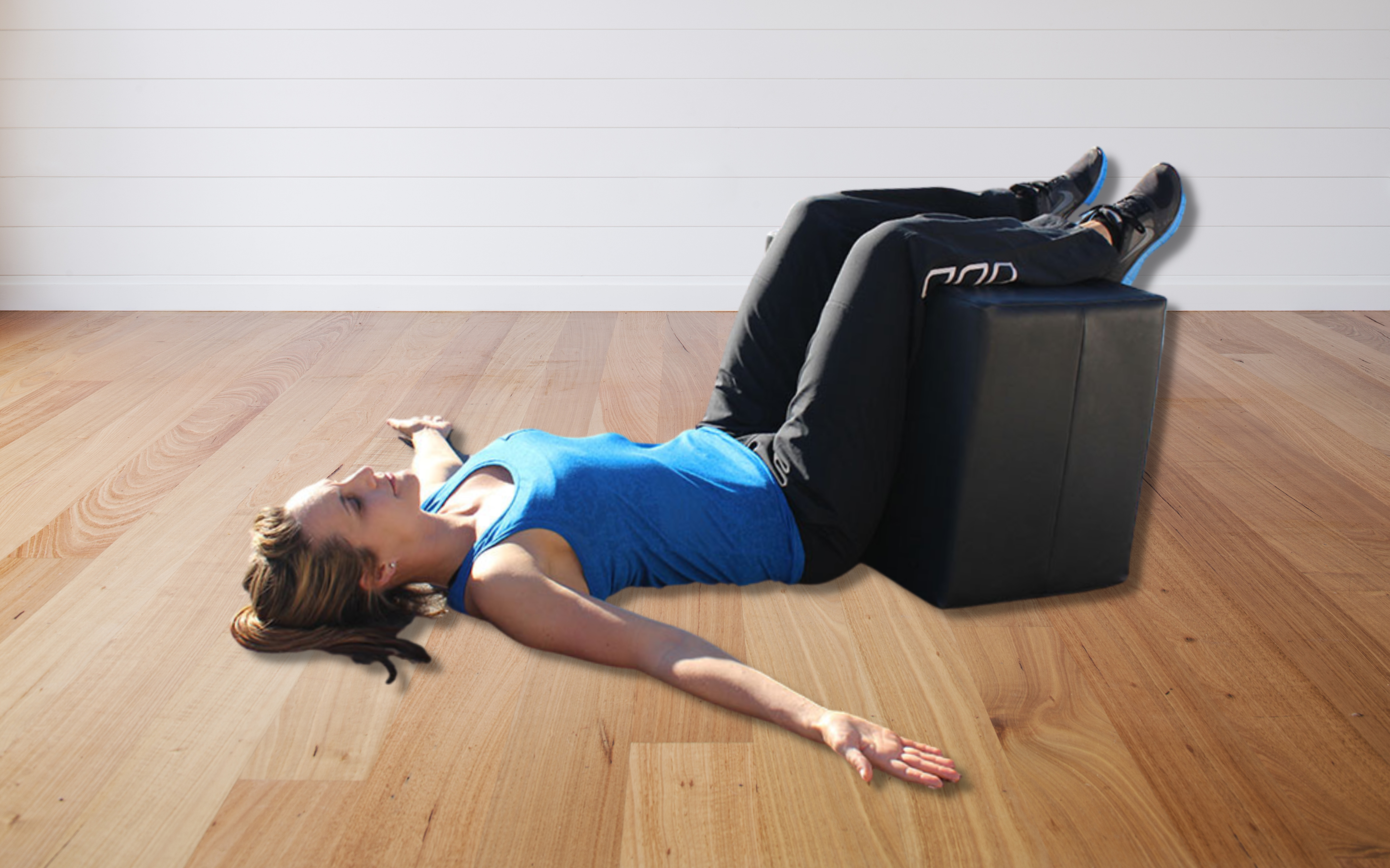 how to perform the static back by laying on floor and putting legs over large block